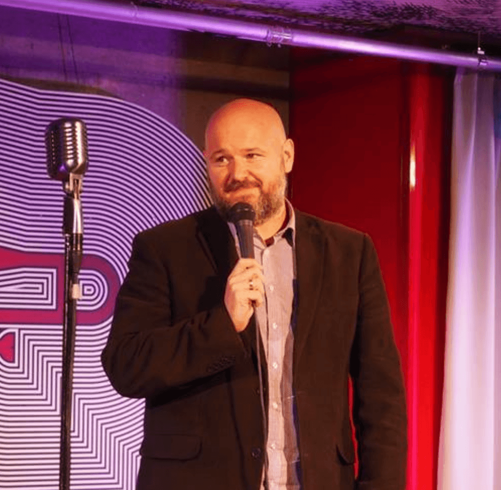 Christian A. Dumais on stage. Talking about English editing.